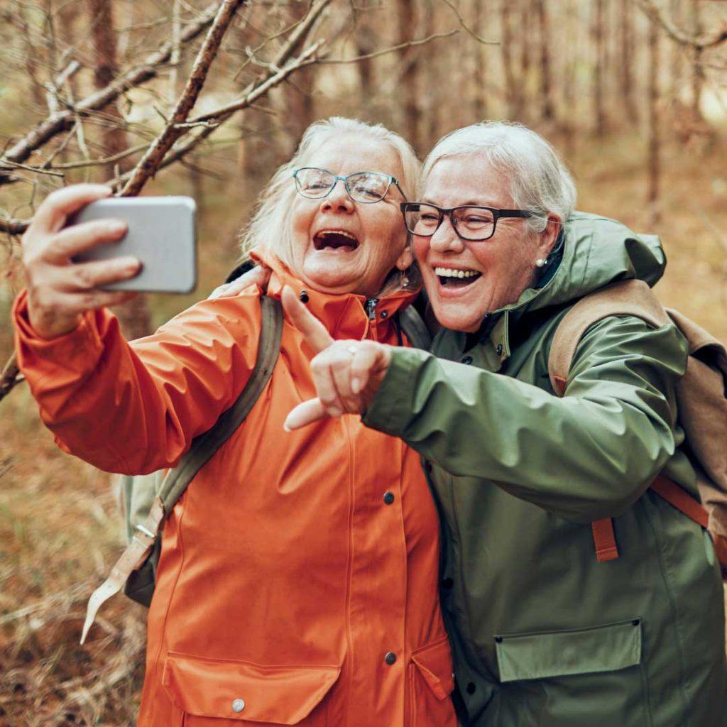 two older women outside taking selfie