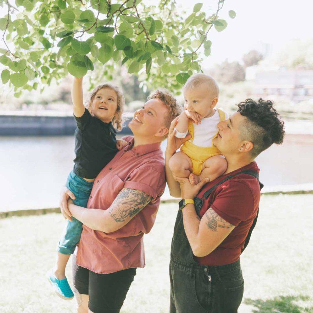 gay couple each carrying a kid 